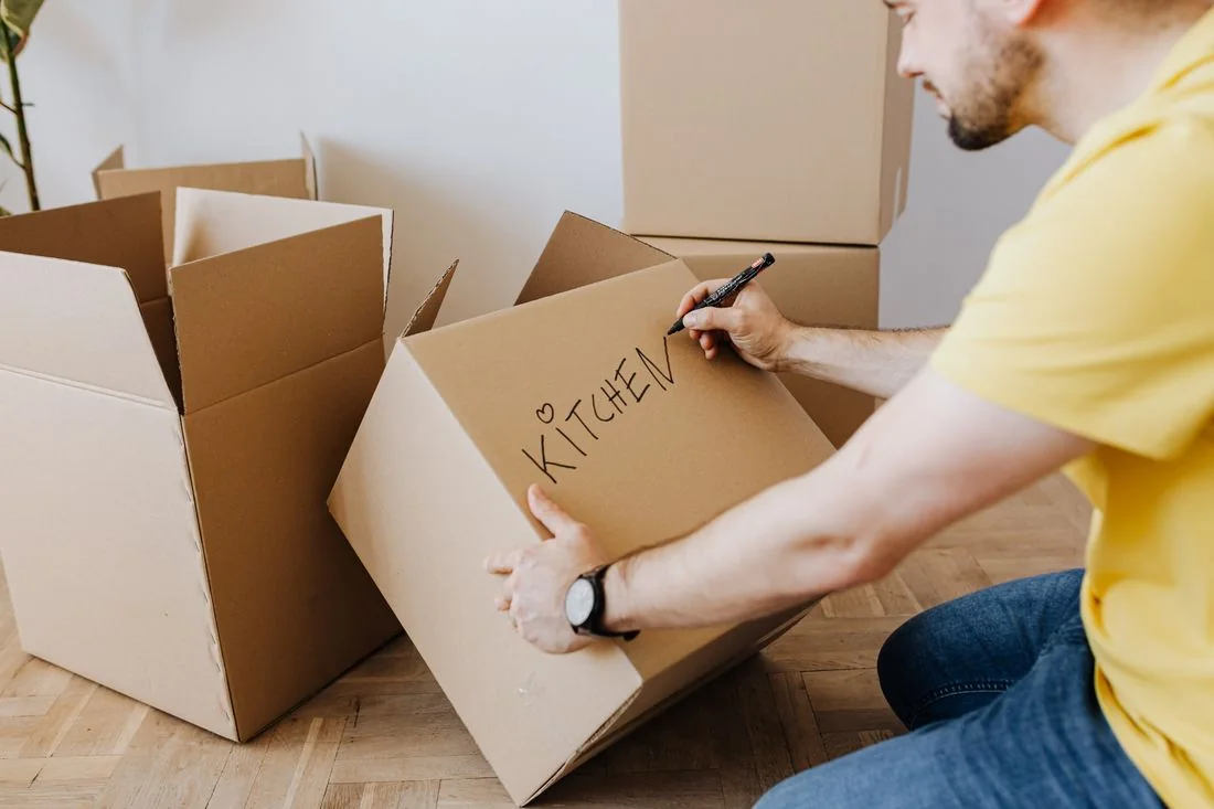 Illustrative labelling and protective packing of belongings before moving